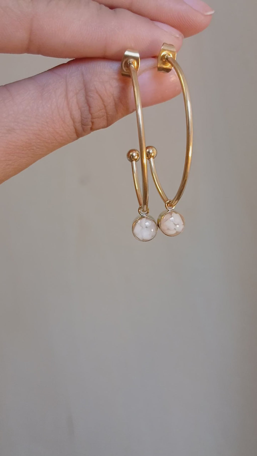 Hoop earrings with white natural stone pendant